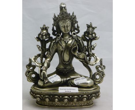 A silvered model of a seated deity