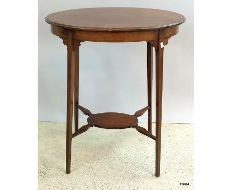 An Edwardian mahogany oval lamp table