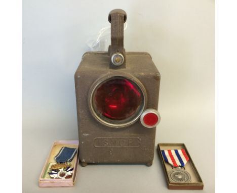 A WW2 French SNCF railway signal lamp in full working order with a 1941 French Railway medal and an associated French Railway