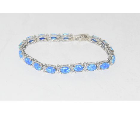 A silver CZ & blue cabuchon opal line bracelet