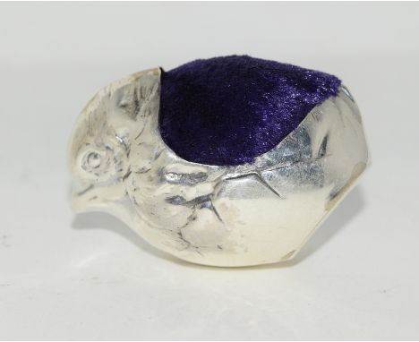 A silver pin cushion in the form of a chick