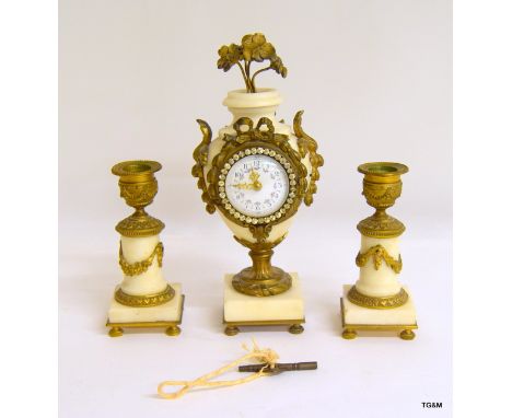 A mantle set comprising of a clock & two candlesticks