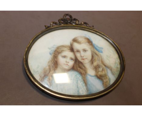 AN EARLY 20TH CENTURY GILT FRAMED PORTRAIT MINIATURE OF TWO YOUNG GIRLS