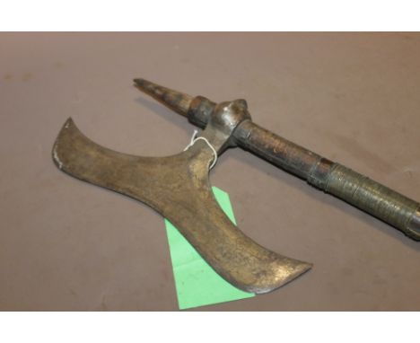 A LATE 18TH/19TH CENTURY INDIAN BULLOVA AXE, 29 cm blade attached to a 94 cm wooden shaft with wire binding, bottom spike to 