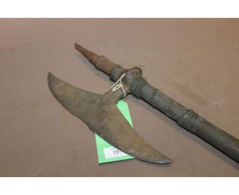 A LATE 18TH/EARLY 19TH CENTURY INDIAN BULLOVA AXE, with 30 cm blade, the 92 cm wooden shaft with wire binding (some loose) to