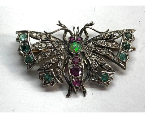 Diamond emerald and ruby set butterfly brooch set in silver and gold backed measures approx 41mm by 26mm 