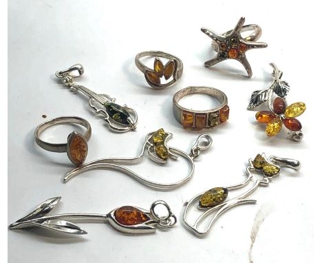 Selection of silver and amber jewellery rings pendant etc 