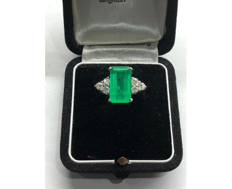 Platinum Emerald and diamond ring large central emerald measures approx 15mm by 8.5mm set with diamonds either side,&nbsp;thi