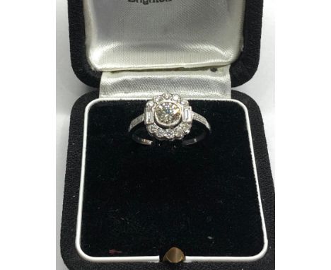 Platinum and diamond cluster ring central diamond measures approx 5.5mm dia set with diamonds around 