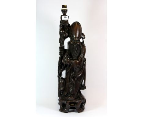 A large early 20th century Chinese carved hardwood figure of Shoo Lao, mounted as a table lamp, H. 59cm.