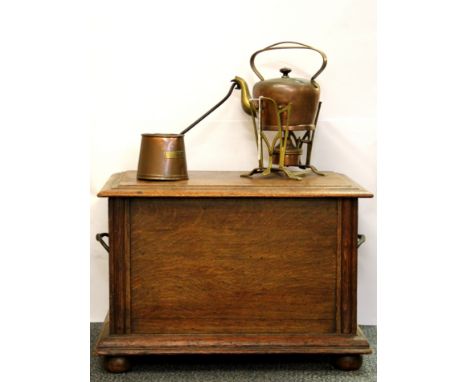 An oak fireside box, with an Arts and Crafts spirit kettle and cider ladle.