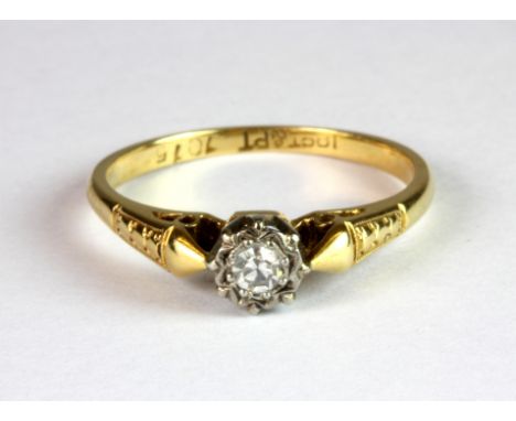 An 18ct gold and platinum (stamped 18ct & plat) diamond solitaire ring (K.5).