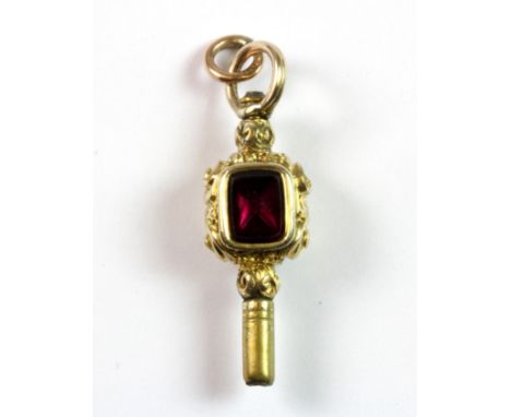 A yellow metal (tested minimum 9ct gold) agate and tourmaline set pocket watch key.