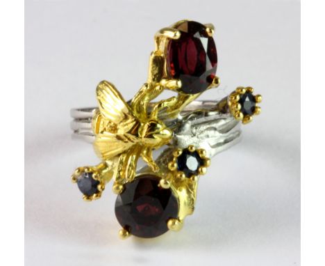 A Hana Maae silver gilt ring set with garnets and sapphires (K).