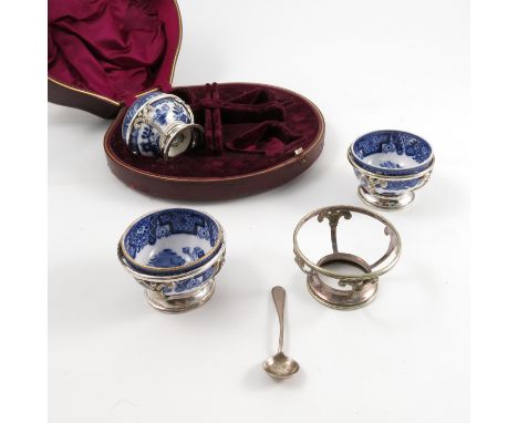Three cased Royal Worcester salt cellars, decorated in underglaze blue, in silver plated stands, together with another stand 