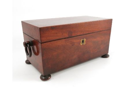 A 19th century mahogany tea caddy, of rectangular form with central mixing bowl and two covered compartments, width 12ins