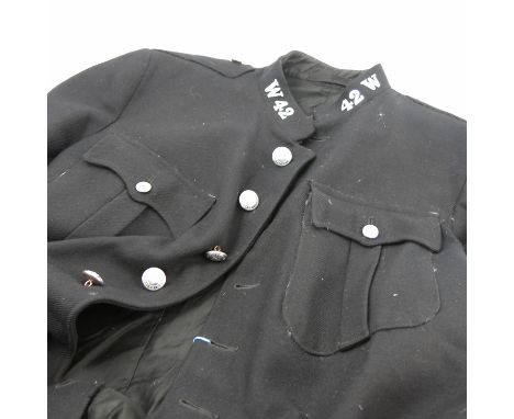 A dark blue great coat, together with two police capes and a dark blue tunic top, possibly police