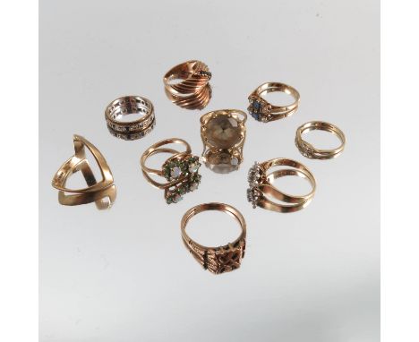 A 9 carat gold smoky quartz ring, together with a diamond illusion set cluster ring, a lovers hearts ring, a wishbone ring, a