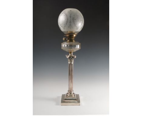 A silver plated and glass oil lamp, with etched shade, raised on a column with cast capital on a square stepped base