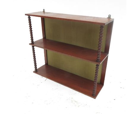 A set of 19th century mahogany shelves, divided by bobbin turned columns, width 25ins