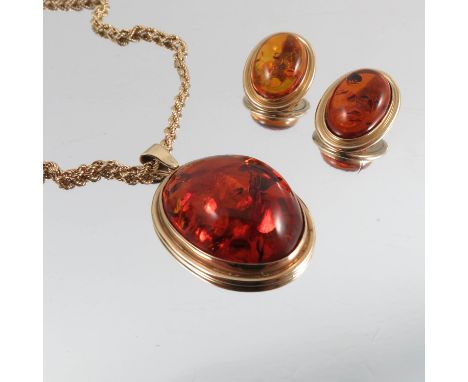 A 9 carat gold amber pendant, on a 9 carat gold rope chain, together with a pair of 9 carat gold amber earclips, 27g gross