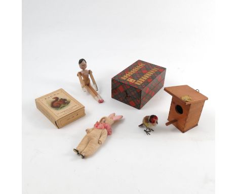 A Steiff wooden bird house, together with bird, label to bird house, together with a bisque doll, dressed as a rabbit, a wood
