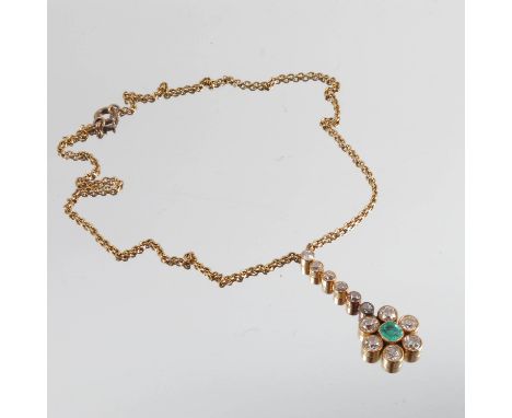 An emerald and diamond pendant, the emerald approximately 5.7mm by 5.3mm by 3.1mm deep, enclosed by six old brilliant cuts to