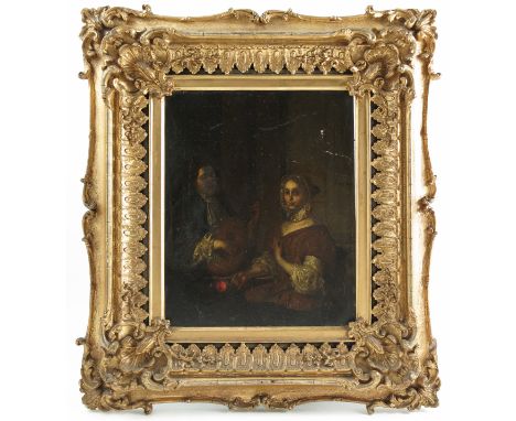An 18th century Flemish school, oil on panel, an interior scene with a man playing a mandolin to a lady, 10ins x 8ins