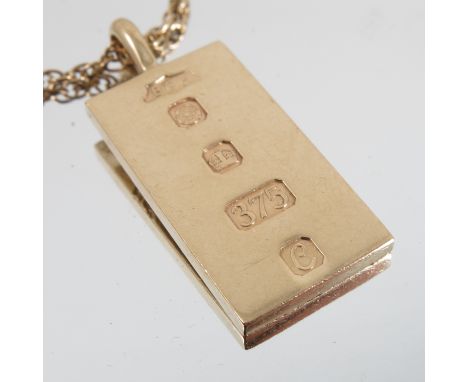 A 9 carat gold ingot, with engraved decoration, together with a 9 carat gold chain   Condition report:  Total weight for ingo