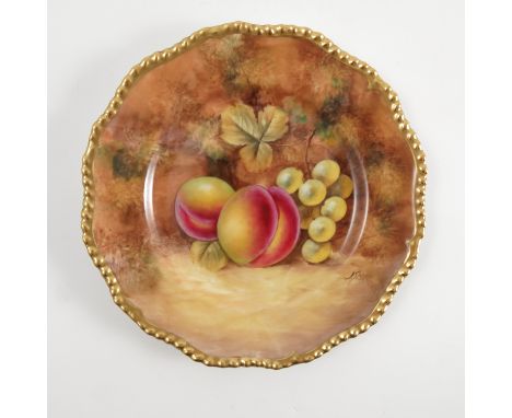 A Royal Worcester cabinet plate, decorated with fruit to a mossy background by J Smith, with shaped gilt edge, diameter 6.75i
