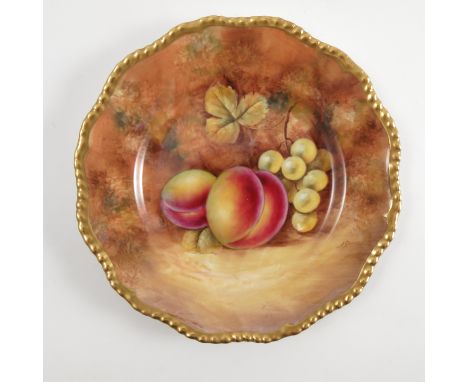 A Royal Worcester cabinet plate, decorated with fruit to a mossy background by J Smith, with shaped gilt edge, diameter 6.75i