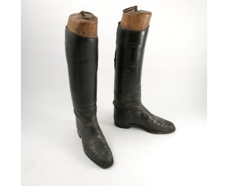 A pair of black leather hunting boots, together with wooden trees   Condition report:  Both boots have damage to the stitchin