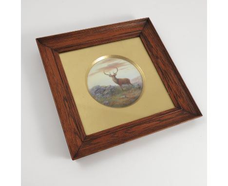 A Royal Worcester circular porcelain plaque, decorated with a stag in rocky landscape by Harry Davis, diameter 4.25ins, with 