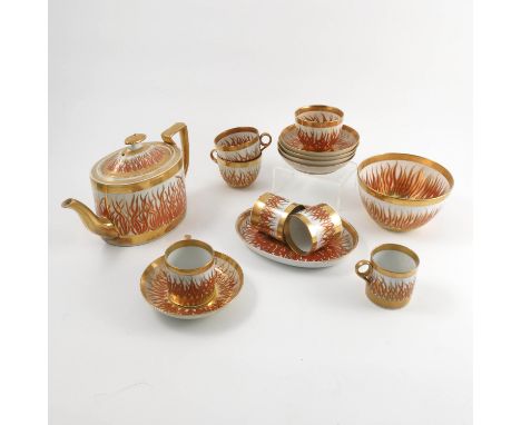 A 19th century Sevres porcelain part tea service, decorated in red and gold with flames, comprising tea pot, stand, slop bowl