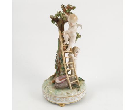 A late 19th century Continental porcelain figure group, of two cherubs with a ladder picking fruit from a tree, blue shield m