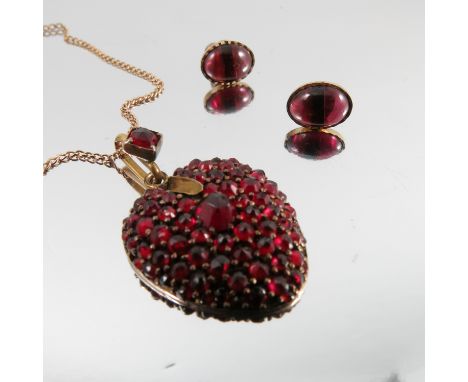 A Bohemian garnet pendant, on a chain, together with a pair of earstuds   Condition report:  Pendant - set in gold plate, sto