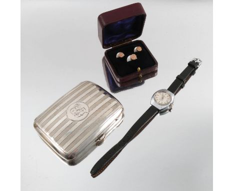 A silver cigarette case, 84g (2.7 troy ozs) gross, together with a cased set of mother or pearl dress studs, and a lady's sta