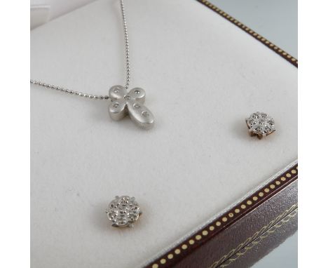 An 18ct white gold diamond set cross, on an 18ct white gold chain, together with a pair of earstuds, 3.9g gross, cased
