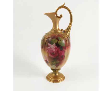 A Royal Worcester ewer, decorated with roses by J Southall, with gilded neck, handle and raised on a circular pedestal foot, 