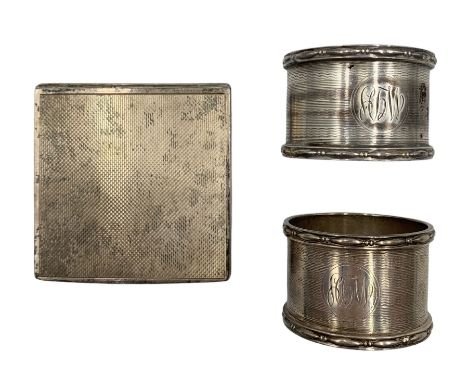 Engine turned square silver powder compact with interior mirror London1946 and two silver serviette rings