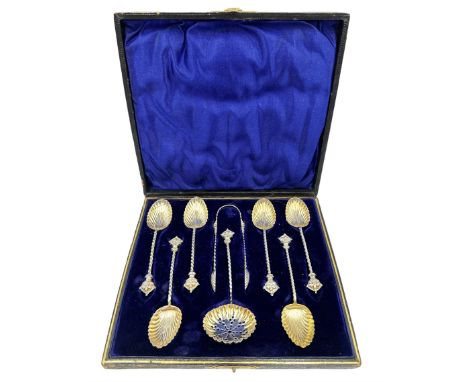 Set of six silver coffee spoons with gilded shell shape bowls, spiral stems and crown finials with matching tongs and sifting