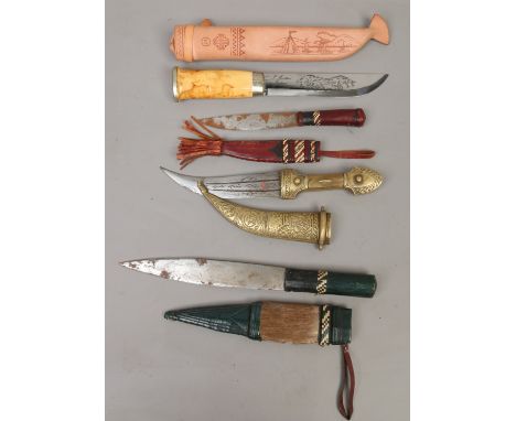 Four hunting knives in sheaths including Indian brass mounted examples.