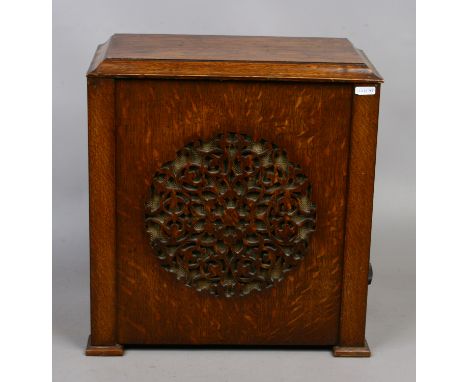 An oak cased speaker with fretwork front.