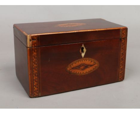 A Victorian marquetry inlaid tea caddy.