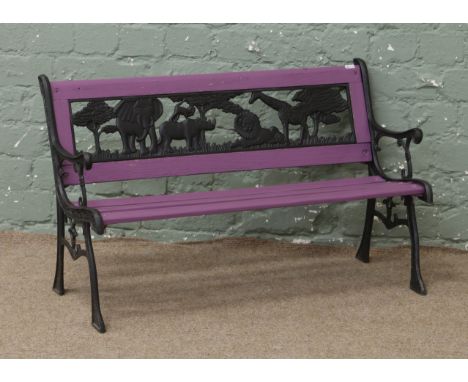 A childs garden bench with African animal theme back panel and purple painted seat.