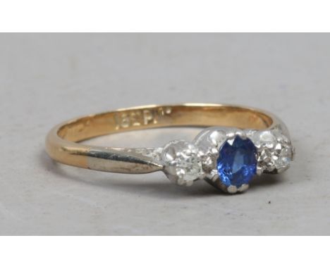 An 18ct gold and platinum three stone sapphire and diamond ring, size K.