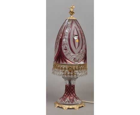 A cut glass table lamp with gilt finial and amethyst flash decoration.