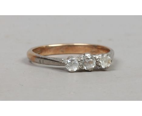 A 9ct gold ring set with three white paste stones, size M.