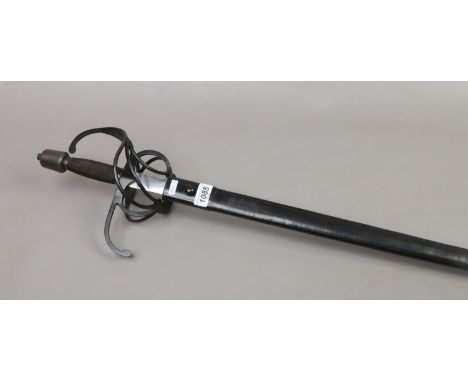 A decorative rapier sword with ornate hand guard and black leather scabbard.