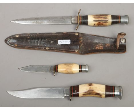 An Atlanta hunting knife in leather sheath and two similar.